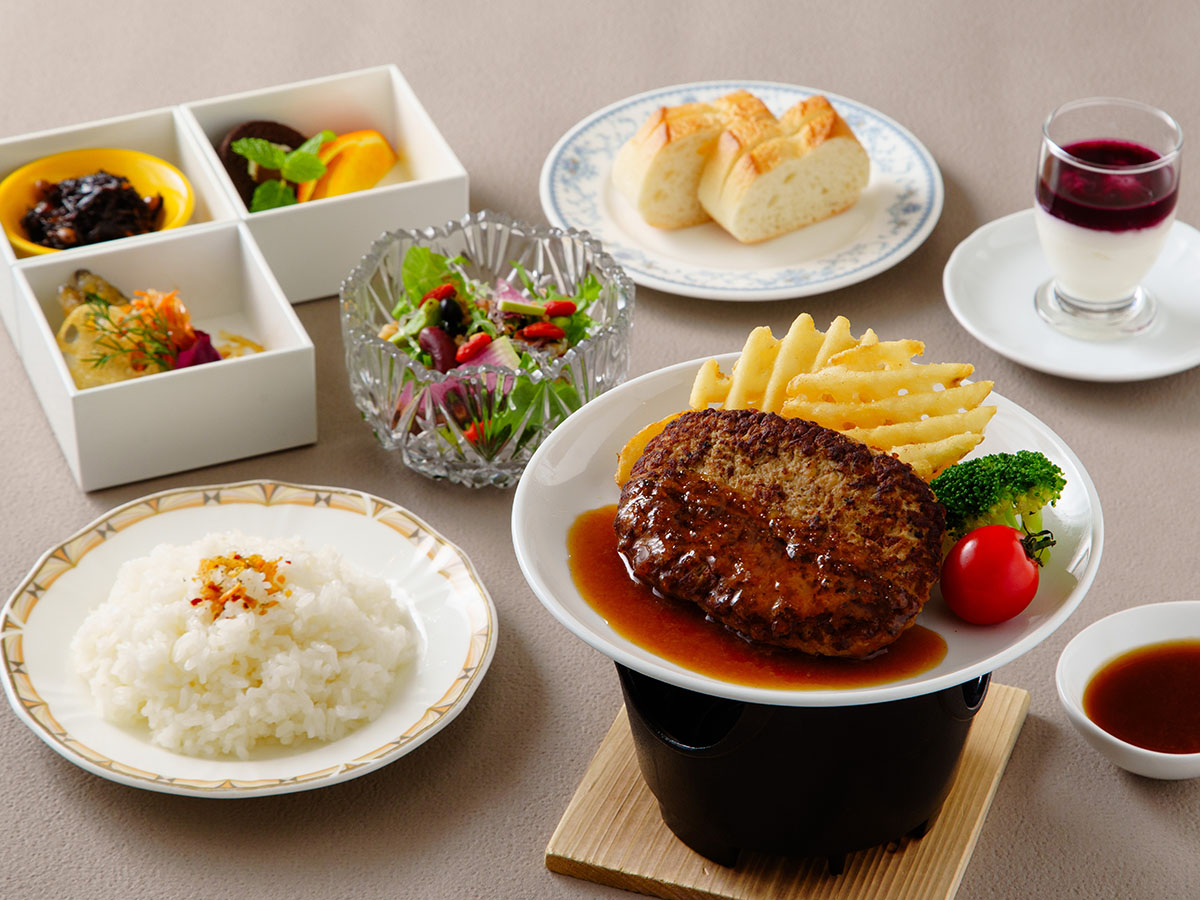 本日のハンバーグ。玉手箱三段重、キヌアサラダ、ソイビネガーカクテル、パンもしくはライス、スープバーが付いたセットメニュー。